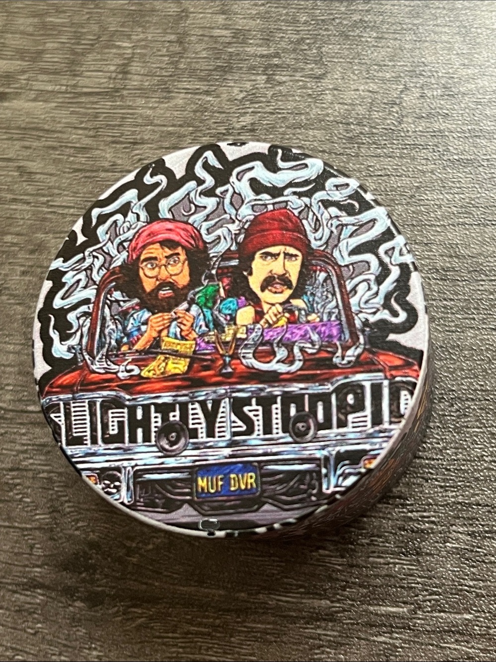 Round Graphic Tin with Colorful Smoking Car Illustration